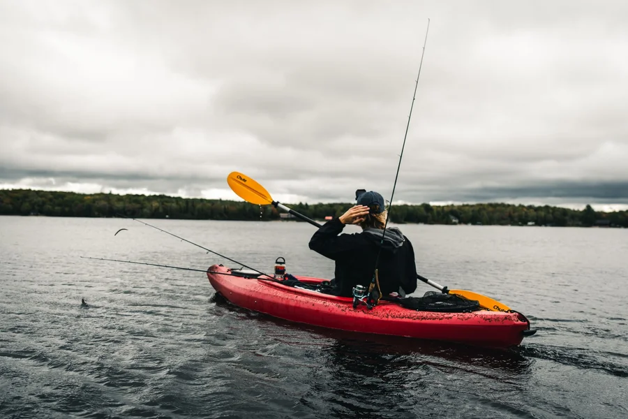 Fishing Kayak Rigged Rod Holders Fishing kayak rigged with fishing rods and tackle crates in storage well