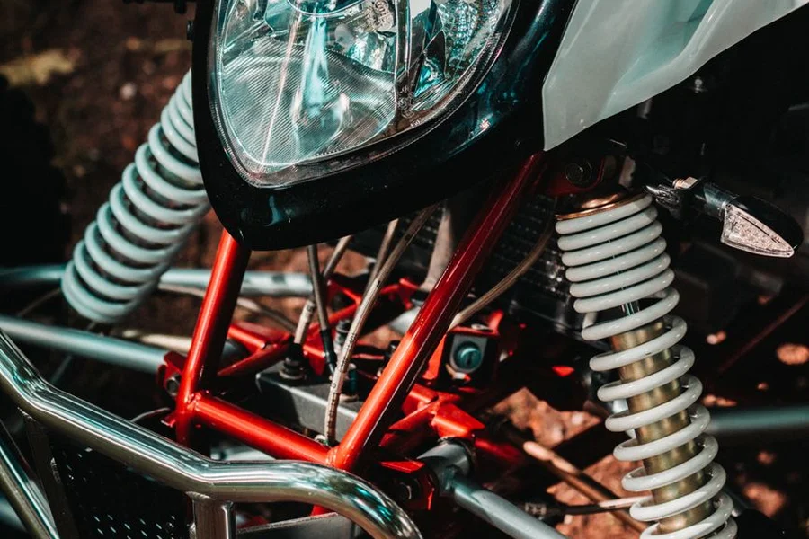 KFX400 Front Suspension Shocks ATV front suspension showing double wishbone a-arms and adjustable shocks