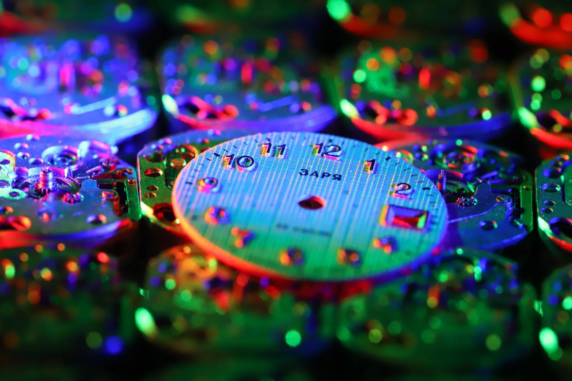 Luminous watch dial glowing brightly in green color in complete darkness