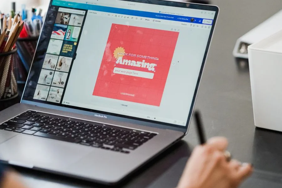 Content creator editing multimedia visual content on modern laptop computer