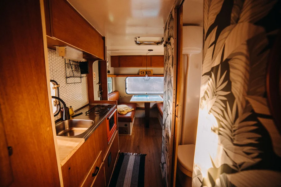 Cozy Warm Camper Interior Cozy camper interior living space with warm lighting comfortable seating and modern cabinets