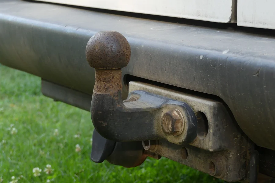 Heavy duty steel trailer hitch receiver mounted on the rear bumper of a towing vehicle
