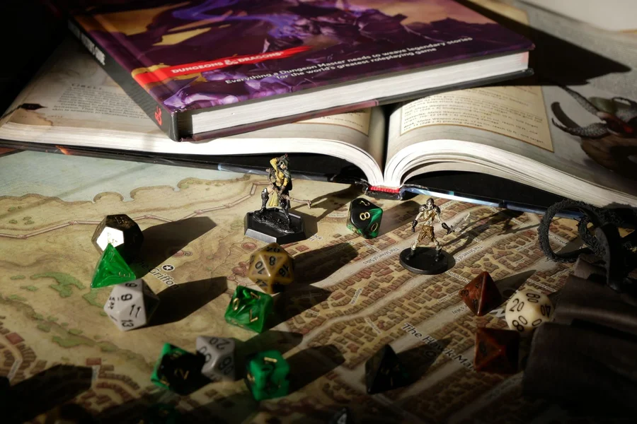 Strixhaven DnD Fantasy Dice Lore Polyhedral roleplaying game dice resting on fantasy lore rulebook